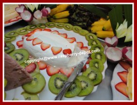 A cheese tray decorated with fruit