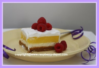 Creamy Lemon Dessert Squares with Fresh Raspberries on Top